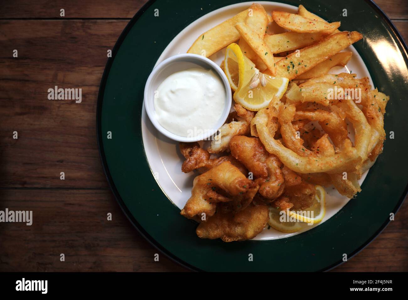 Fish and chips fried fish and potatoes on wood background vintage style Stock Photo