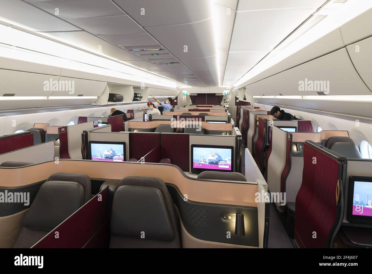 Qatar Airways QSuites cabin on Airbus A350. QSuite is a premium business class seat with doors introduced by Qatar Airways. Boarding at Doha, Qatar. Stock Photo