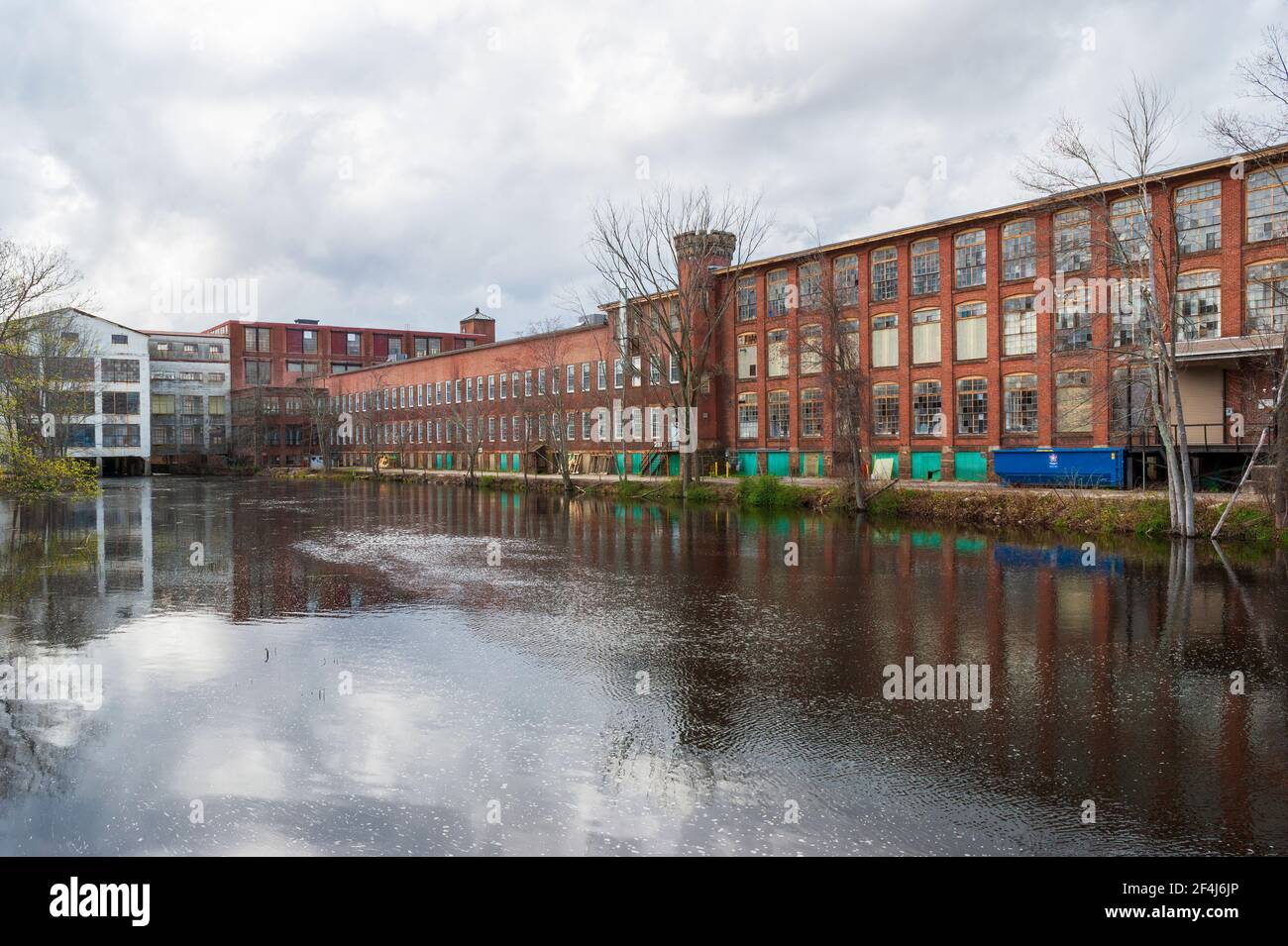 Whitin Machine Works, along the Mumford River, in Whitinsville, MA, It was the largest textile machine manufactory in the world until mid-20th century Stock Photo