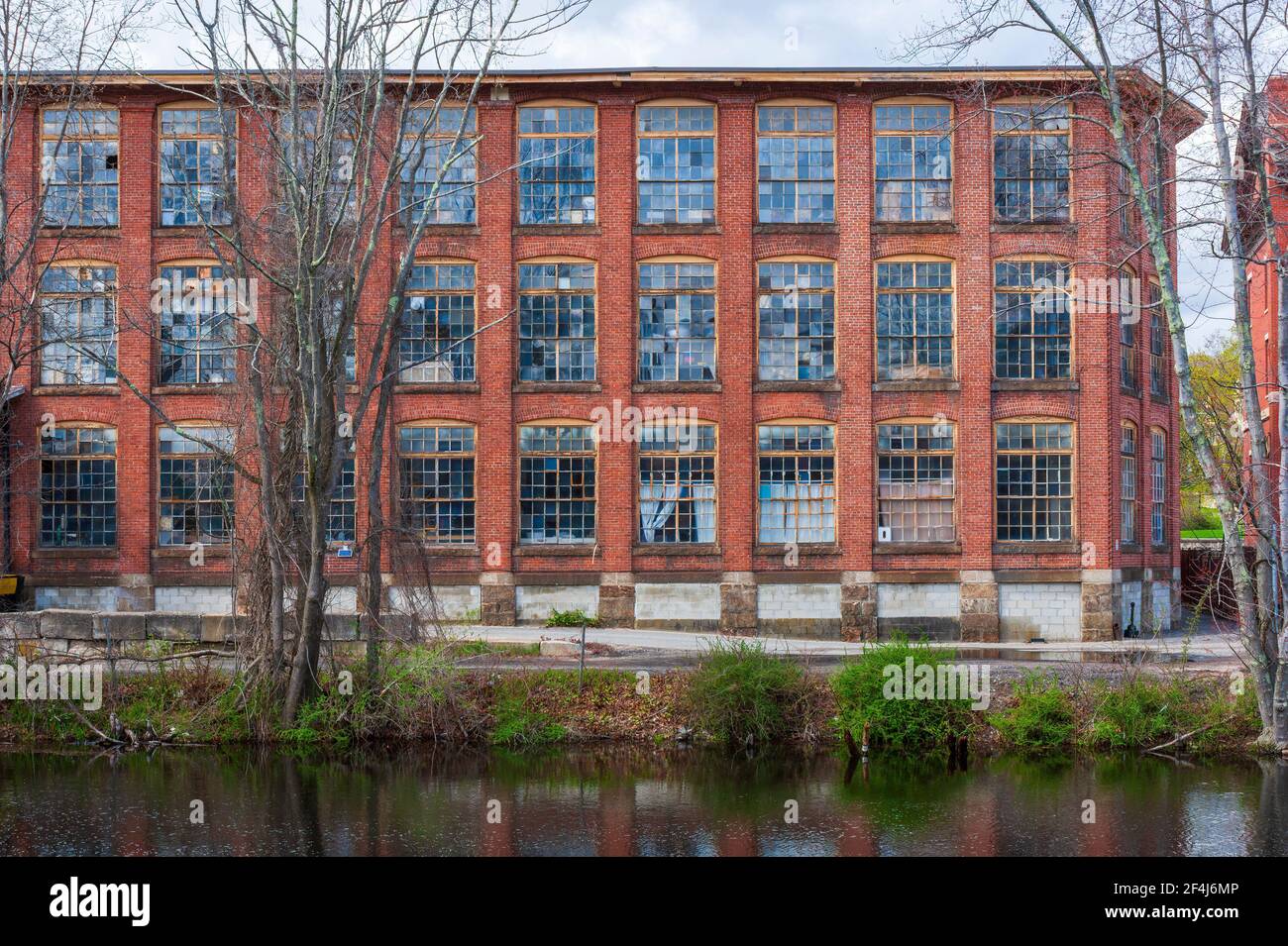 Whitin Machine Works, along the Mumford River, in Whitinsville, MA, It was the largest textile machine manufactory in the world until mid-20th century Stock Photo