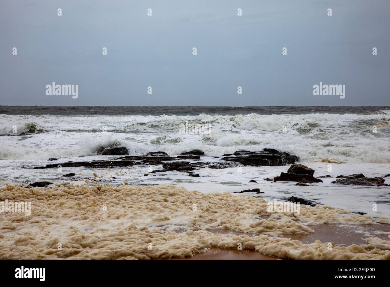 Sydney heavy storms and wild surf with sea foam on the beach during the New South Wales floods of march 2021,Australia Stock Photo