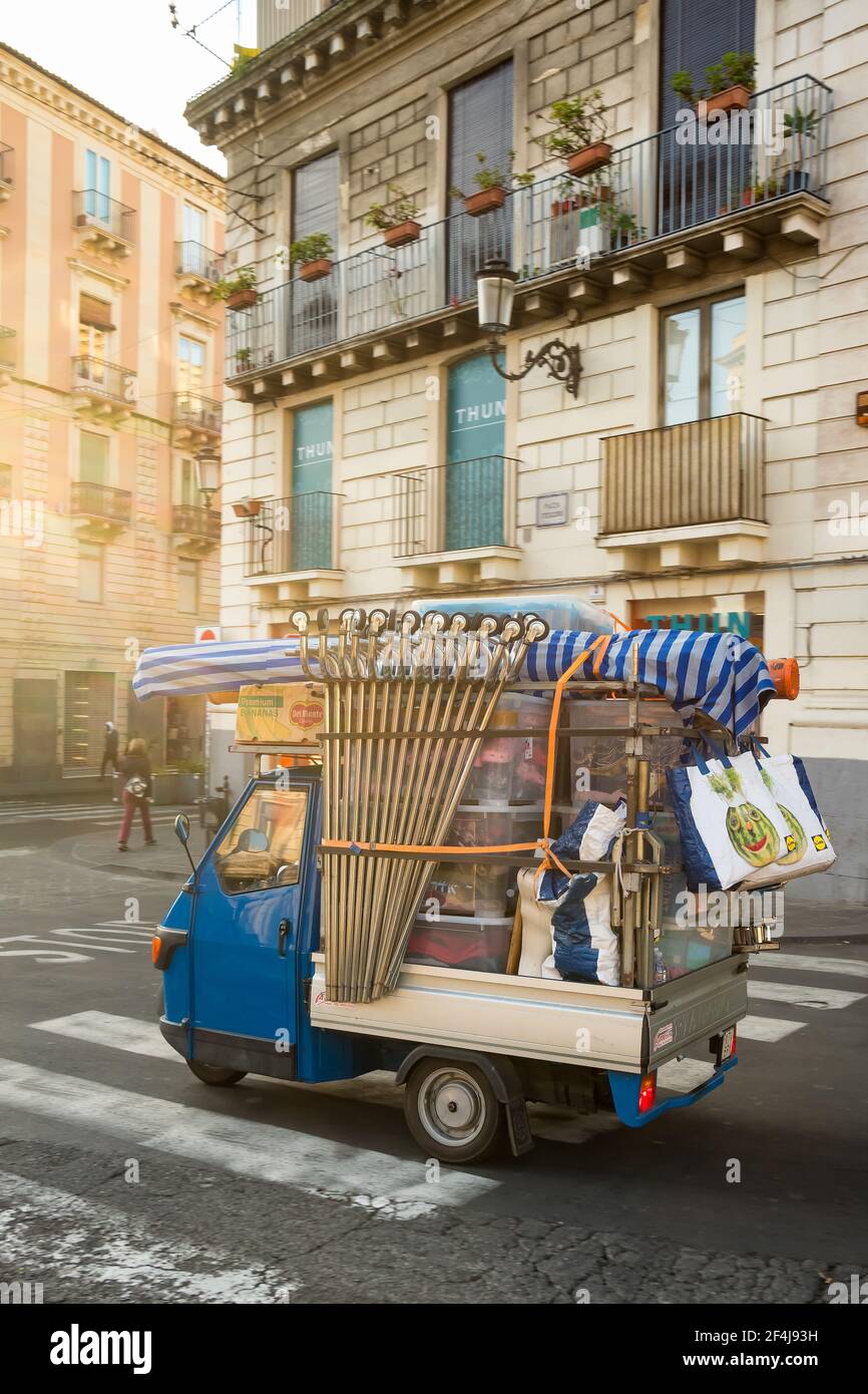 Old Piaggio Ape, a three-wheeled vehicle driving at the streets of Catania in Sicily Stock Photo