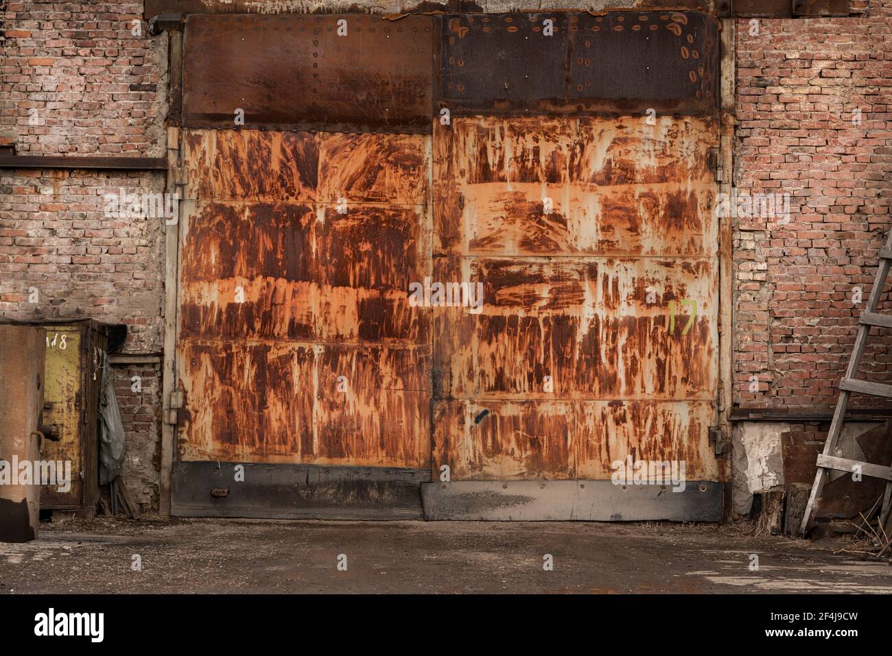 rusty big gates of an industrial abandoned garage, brick walls Stock ...