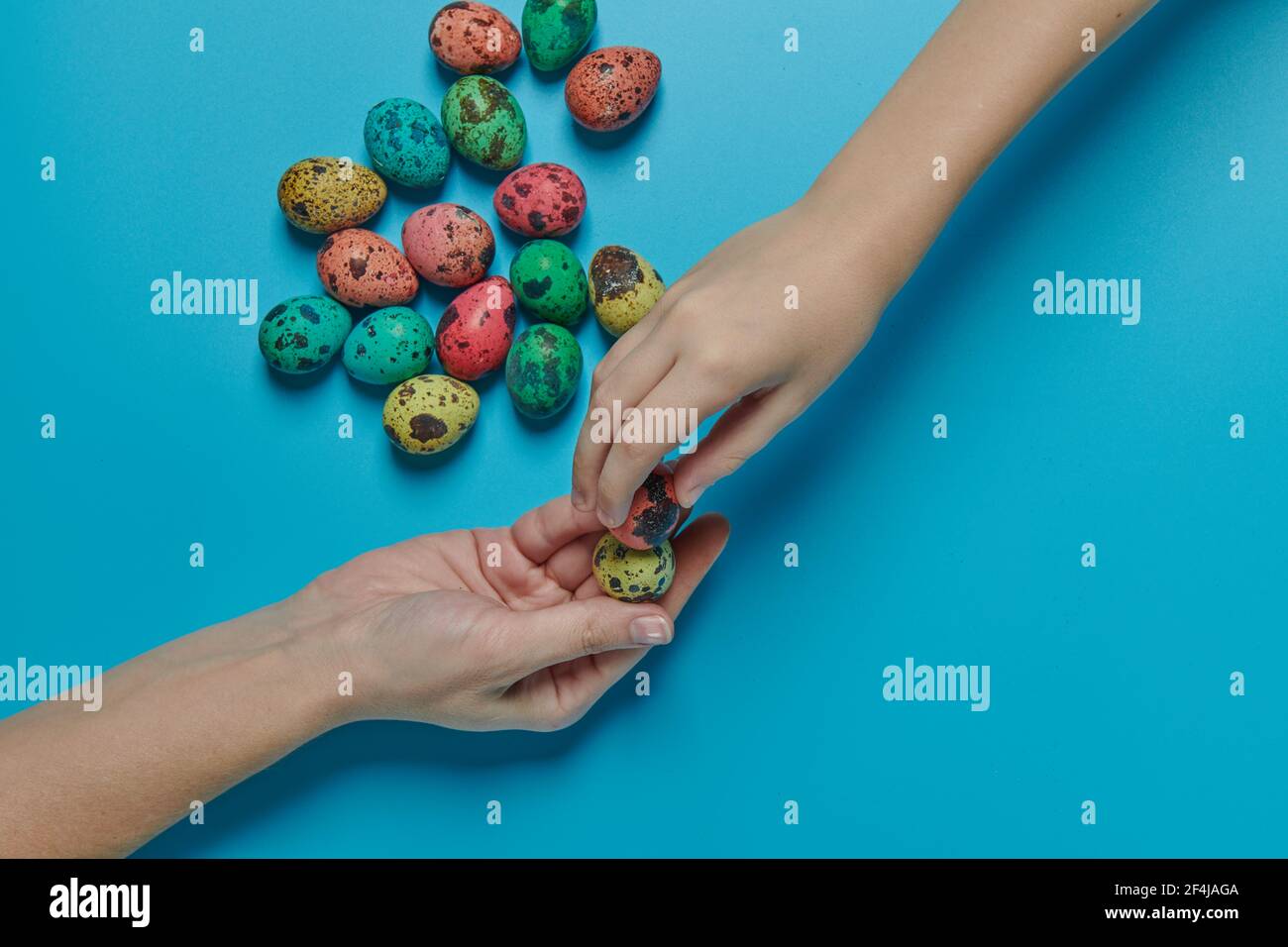 colored eggs for easter and two hands Stock Photo