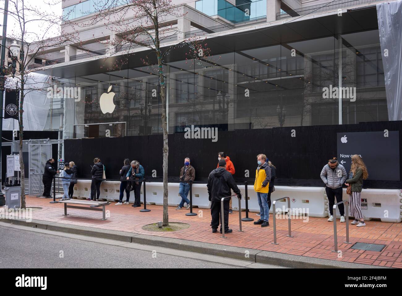 Masked shoppers who had made online reservations line up on Sunday