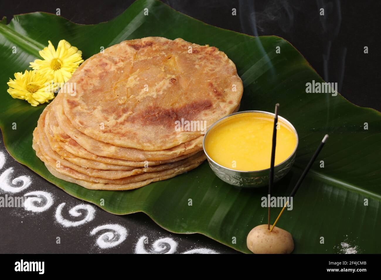 Puran Poli, also known as Holige, is an Indian sweet flatbread from India consumed mostly during Holi festival. Served on banana leaf with pure Ghee o Stock Photo