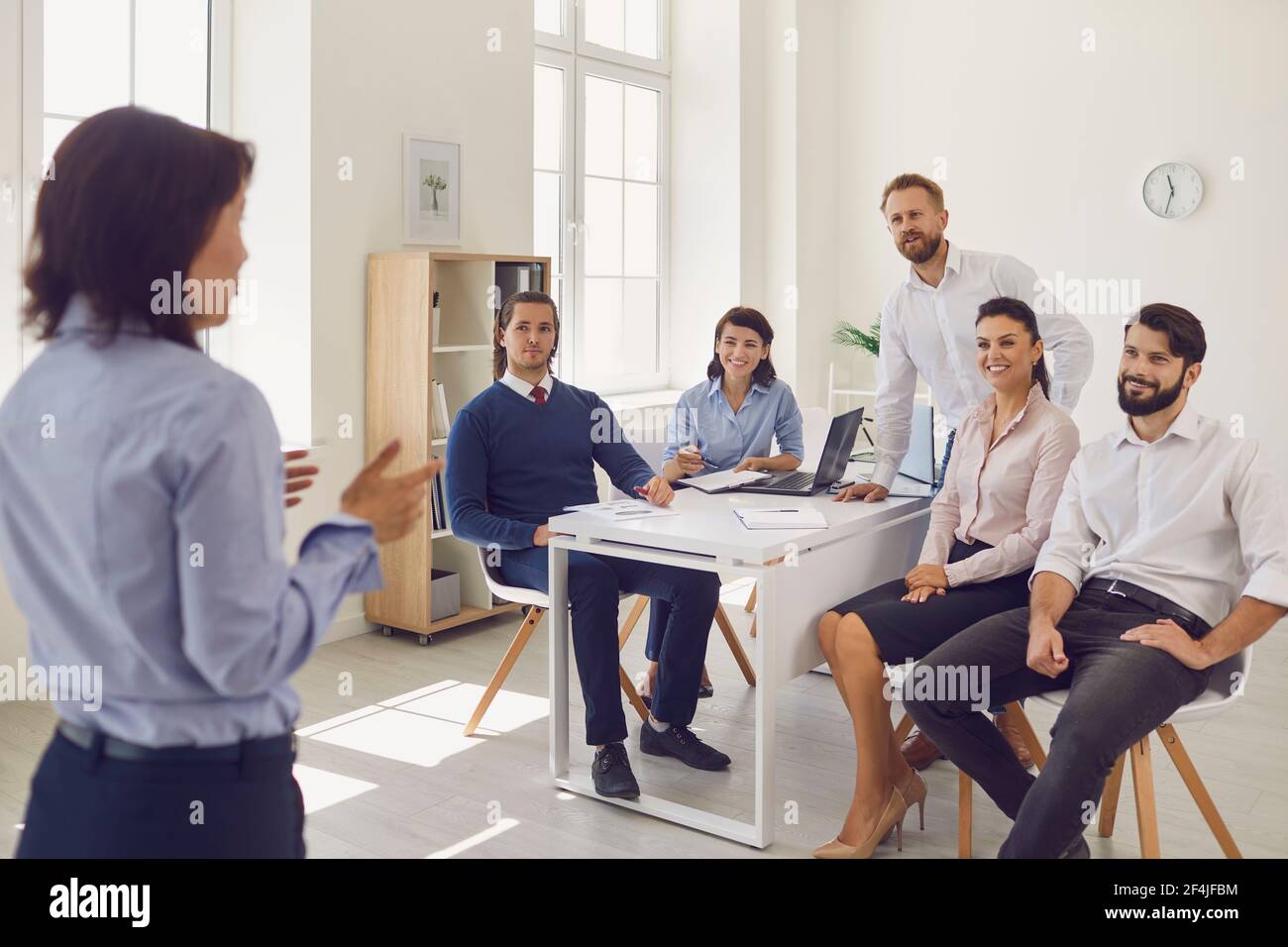 Business executive delivering a presentation to his colleagues during ...
