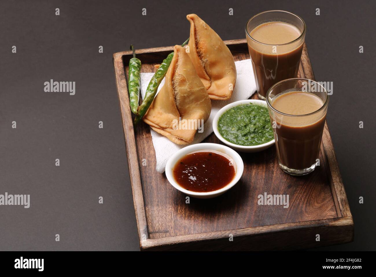 Indian snack Homemade spicy and delicious samosa served with green