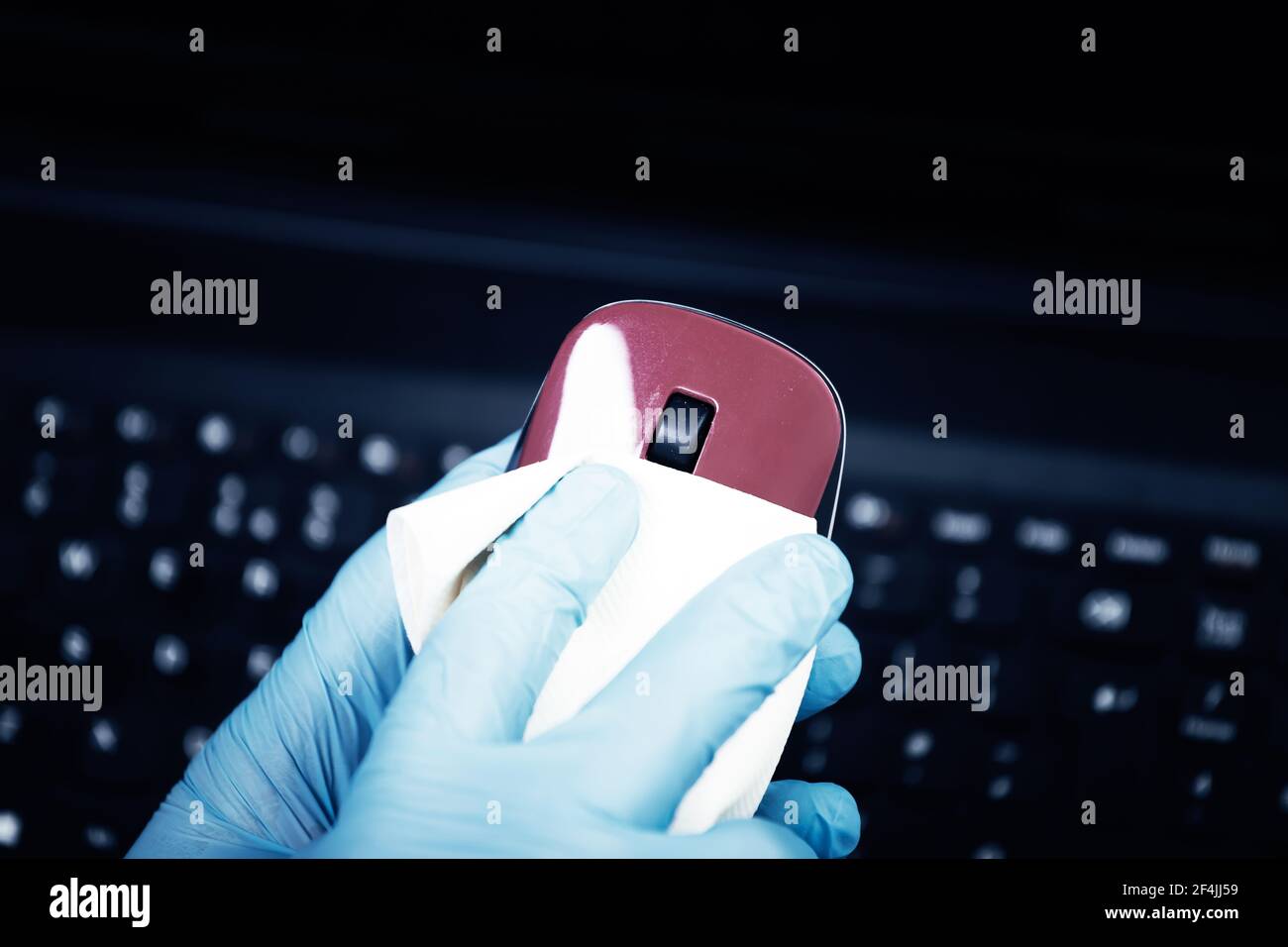 Office sanitizing wiping mouse with disinfectant. Coronavirus COVID19 sanitize cleaning