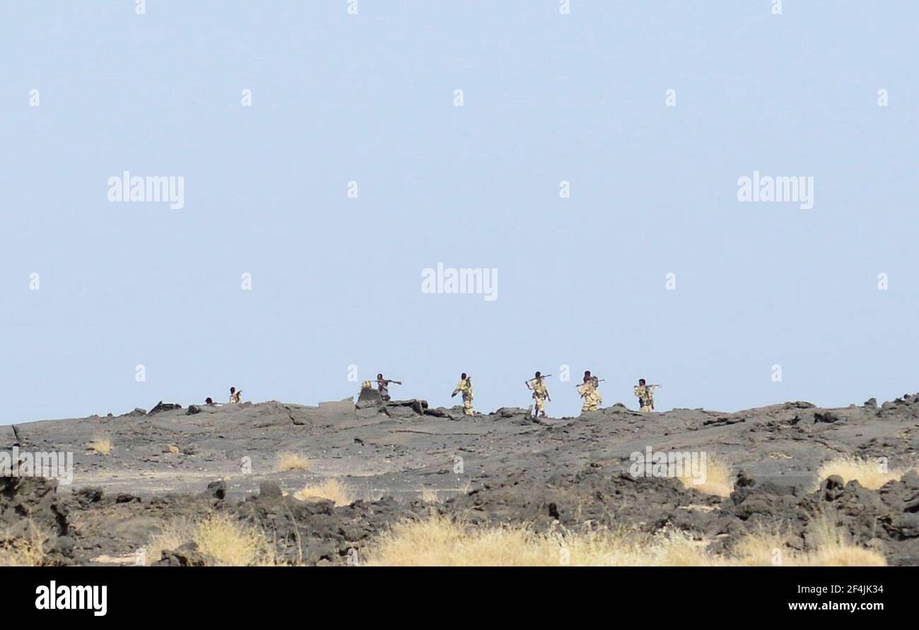 Ethiopian soldiers patrolling in the Danakil Depression close to the Erta Ale volcano. Stock Photo