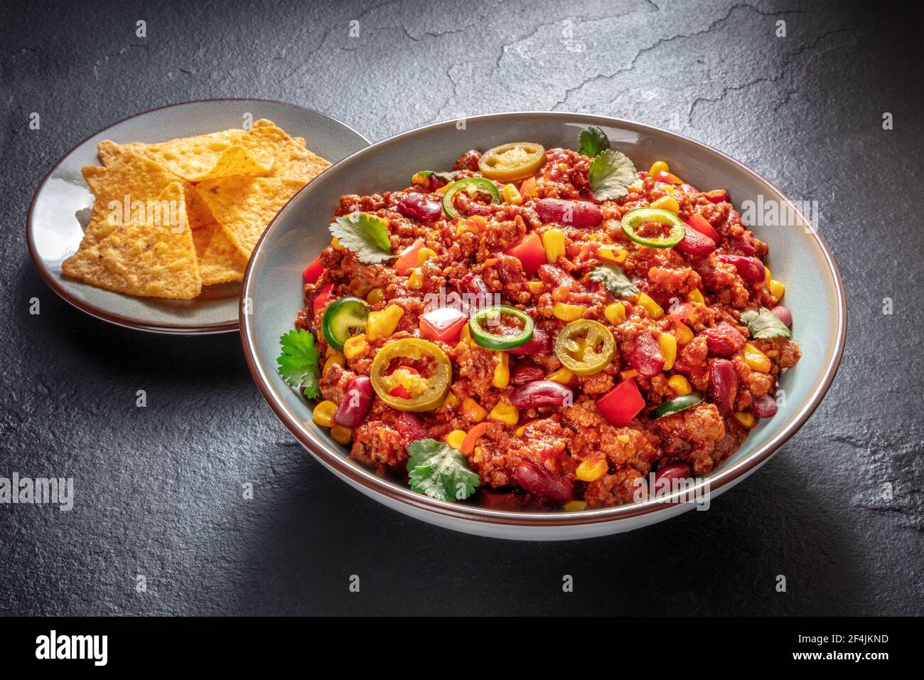 Chili con carne with nachos, hearty stew with beef and beans Stock