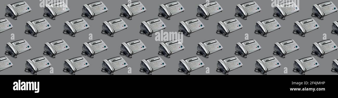 Old office fax machine shot on gray background. seamless pattern with Fax. office equipment, Telephone and fax. Long wide banner Stock Photo