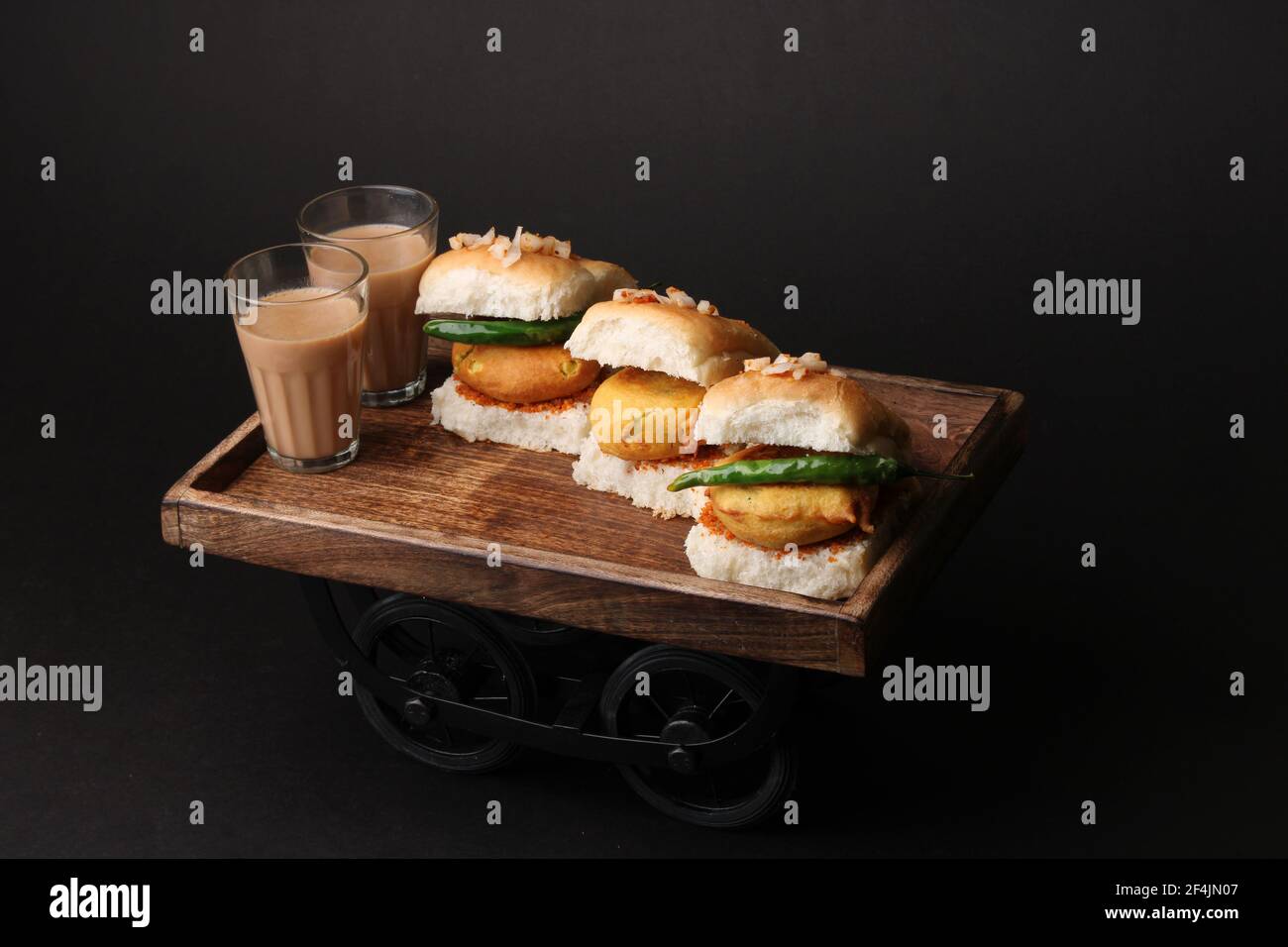 Bombay vada paav is an indian burger. Potato patty is deep fried in gram flour or besan batter and it is served hot with paav or bun like sandwich. It Stock Photo