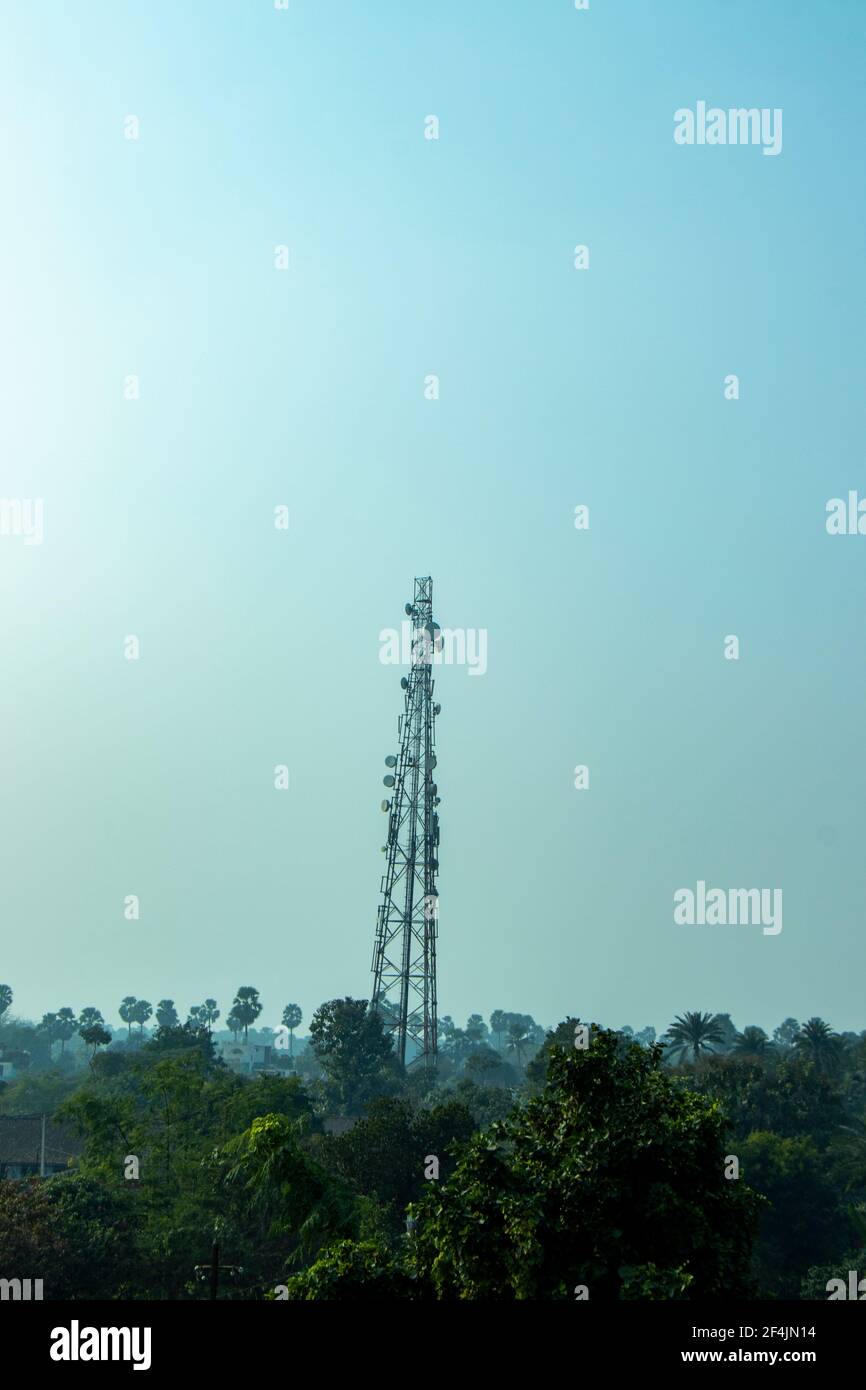 Mobile network tower against sunny sky Stock Photo
