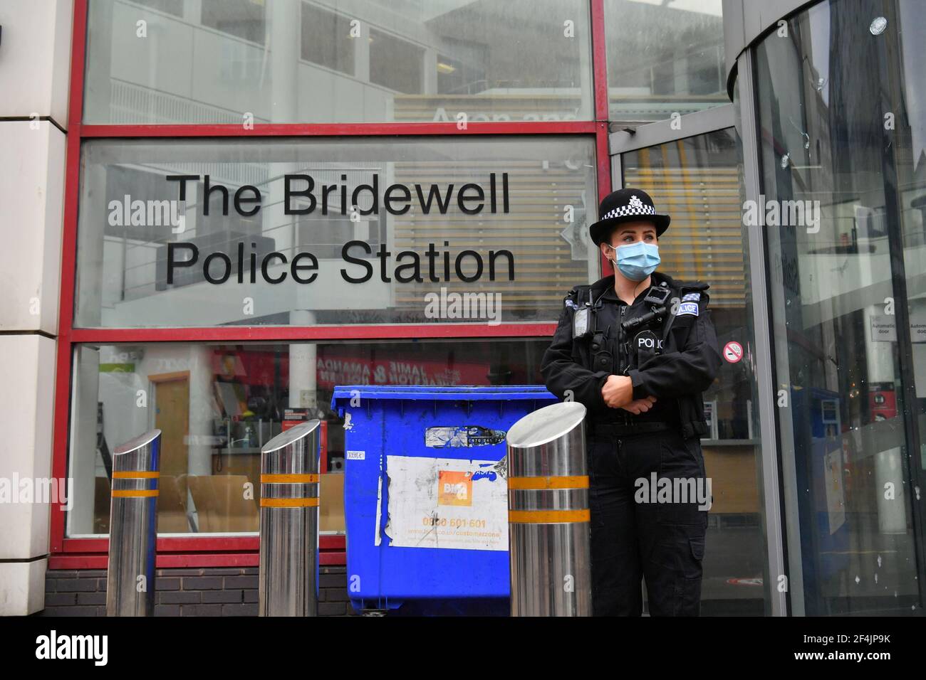A police officer outside of Bridewell Police Station in Bristol, where protesters broke windows and vandalised the building on Sunday following a demonstration against the Government's controversial Police and Crime Bill. Picture date: Monday March 22, 2021. Stock Photo