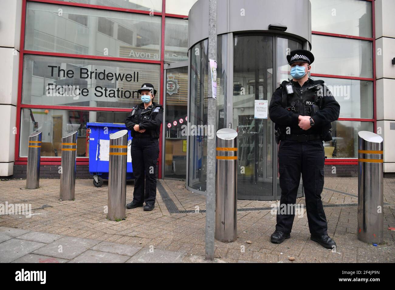 Police officers outside of Bridewell Police Station in Bristol, where protesters broke windows and vandalised the building on Sunday following a demonstration against the Government's controversial Police and Crime Bill. Picture date: Monday March 22, 2021. Stock Photo