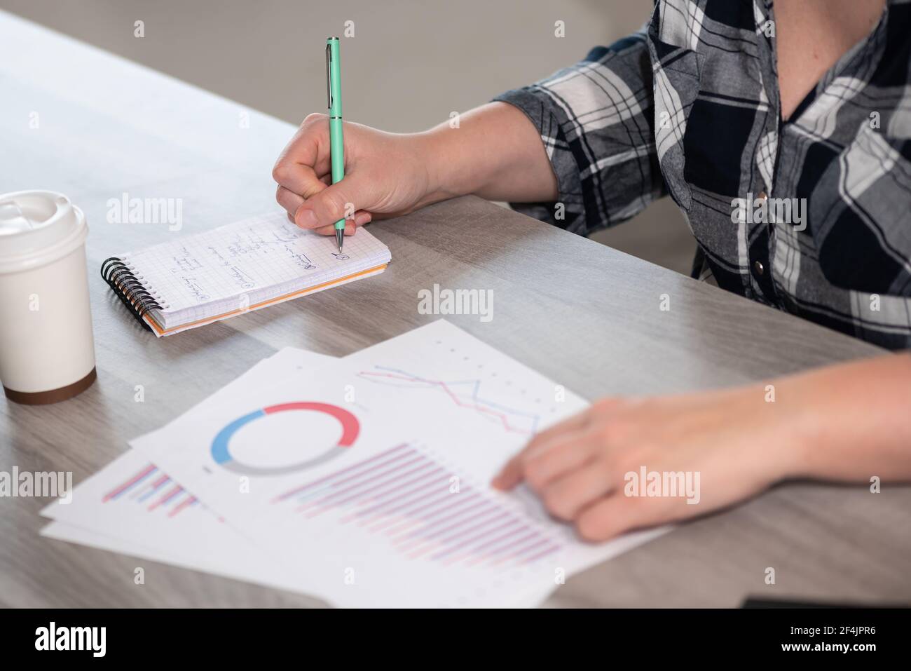 Note Taking Data Businesswoman analyzing marketing data and taking notes Stock Photo - Alamy
