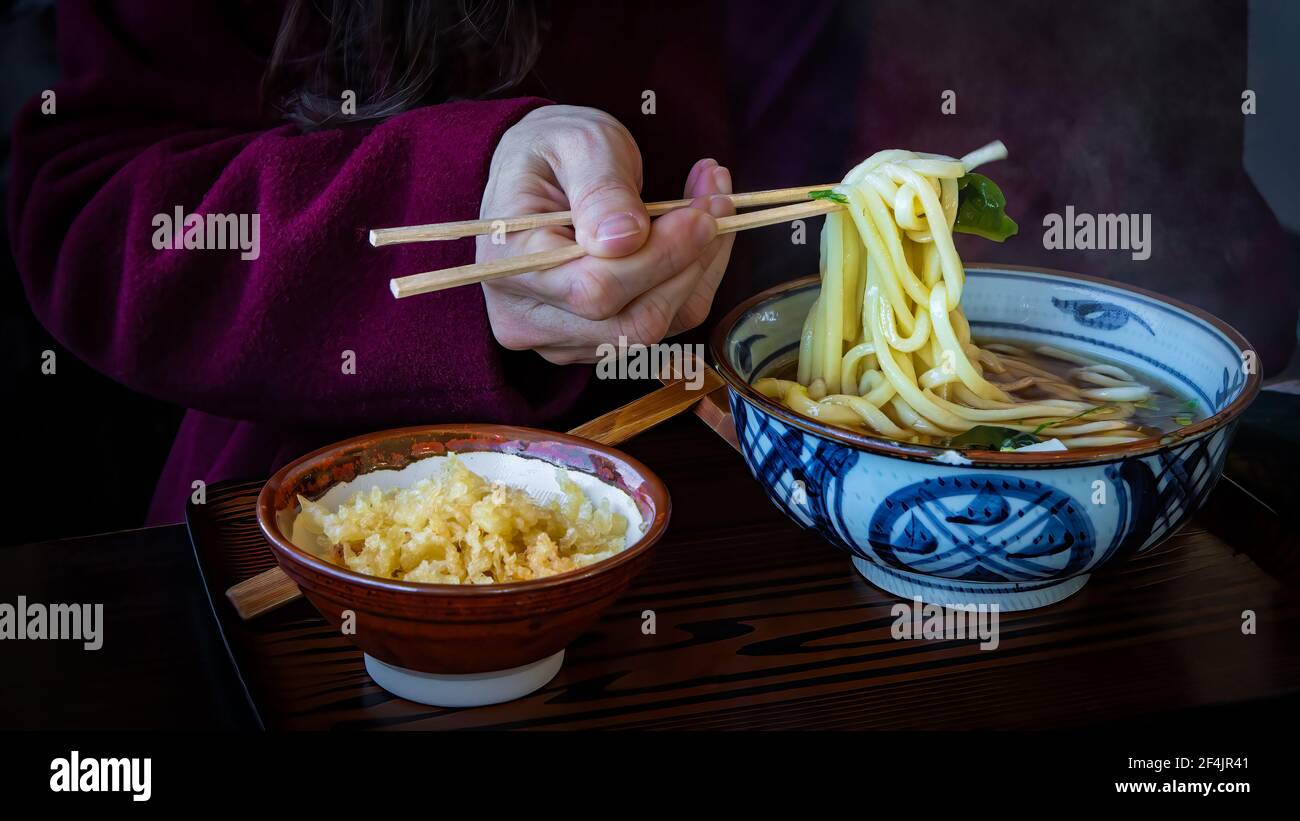 Chopsticks and steamy bowl of ramen at the dinner table in Owakudani