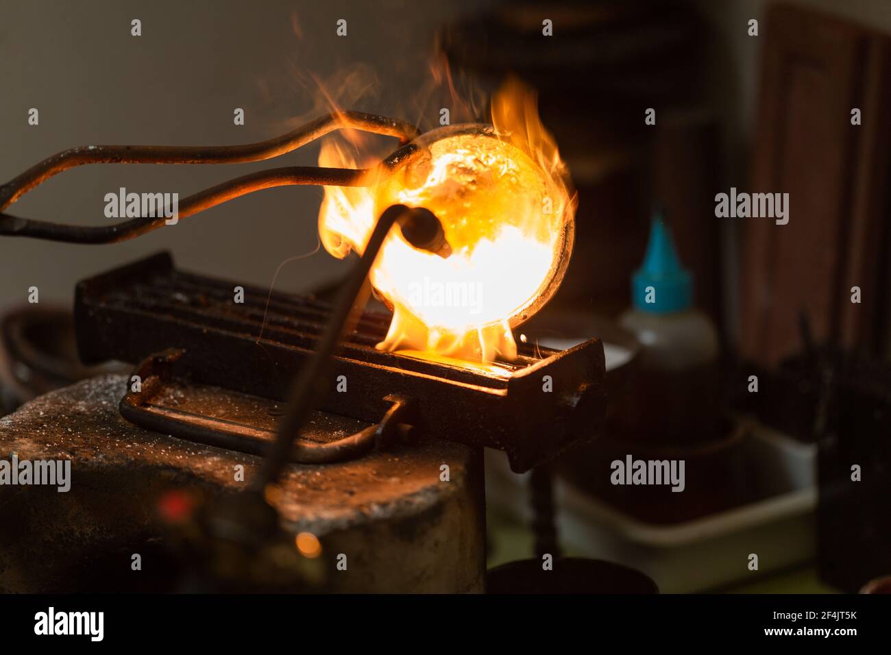 melting with blow torch and foundry of liquid silver from a bowl into a ...