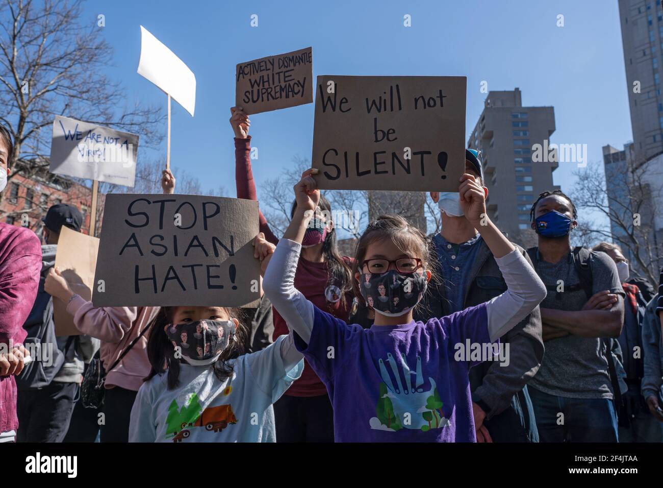 NEW YORK, NY - MARCH 21: Children hold signs that reads 'stop Asian hate' and 'we will not be silent!' at a rally against hate in Columbus Park in the Chinatown neighborhood of Manhattan on March 21, 2021 in New York City. A rally for solidarity was organized in response to a rise in hate crimes against the Asian community since the start of the coronavirus (COVID-19) pandemic in 2020. On March 16 in Atlanta, Georgia, a man went on a shooting spree in three spas that left eight people dead, including six Asian women.Protesters hold placards during a rally against hate in Columbus Park in the C Stock Photo
