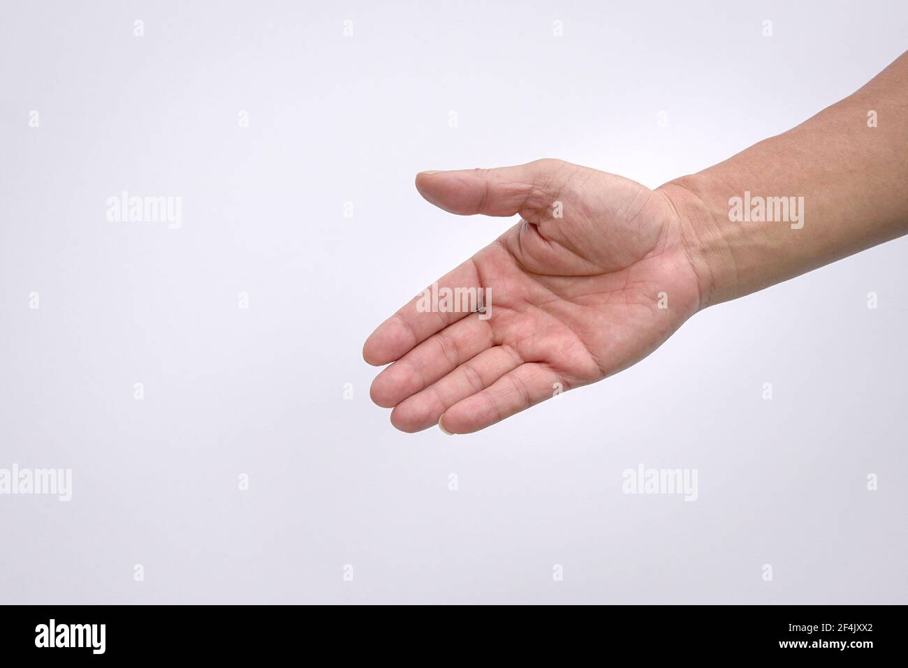 Male hand reaching down, open palm to help gesture. Isolated on white  background Stock Photo - Alamy