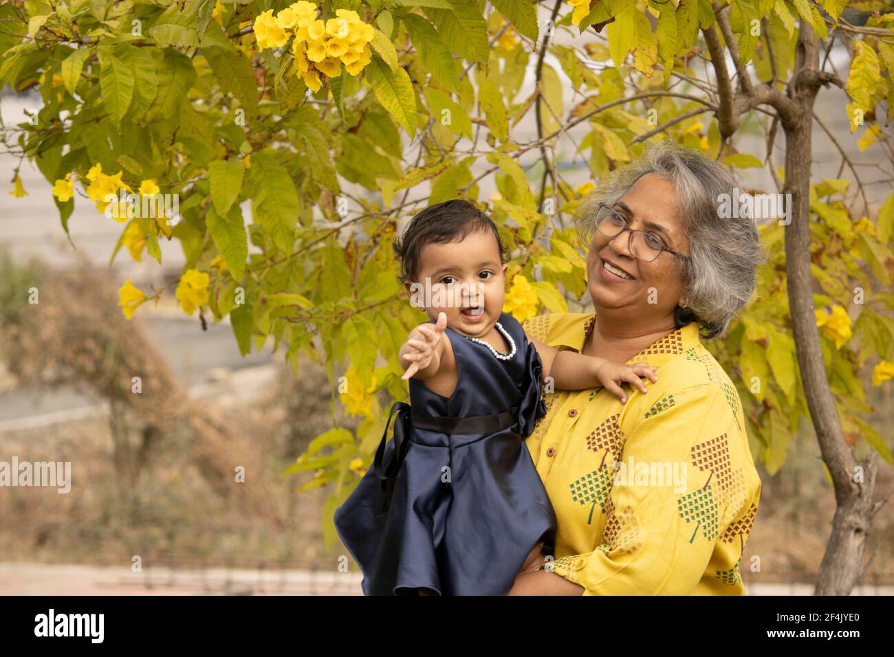 Happy moments with grandma, indian or asian senior lady spending quality time with her grand daughter in garden. Stock Photo