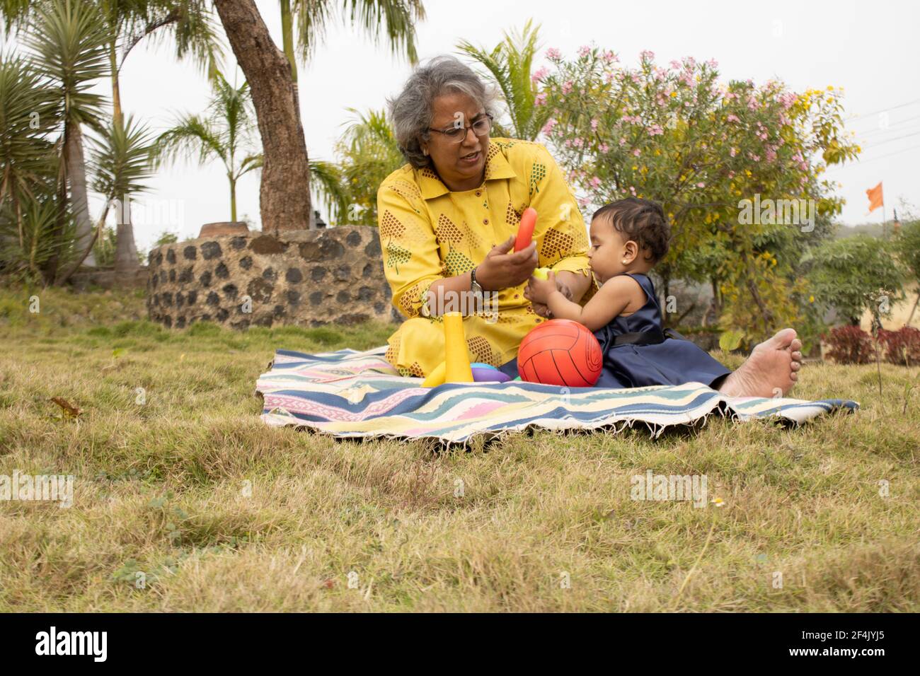 Happy moments with grandma, indian or asian senior lady spending quality time with her grand daughter in garden. Stock Photo