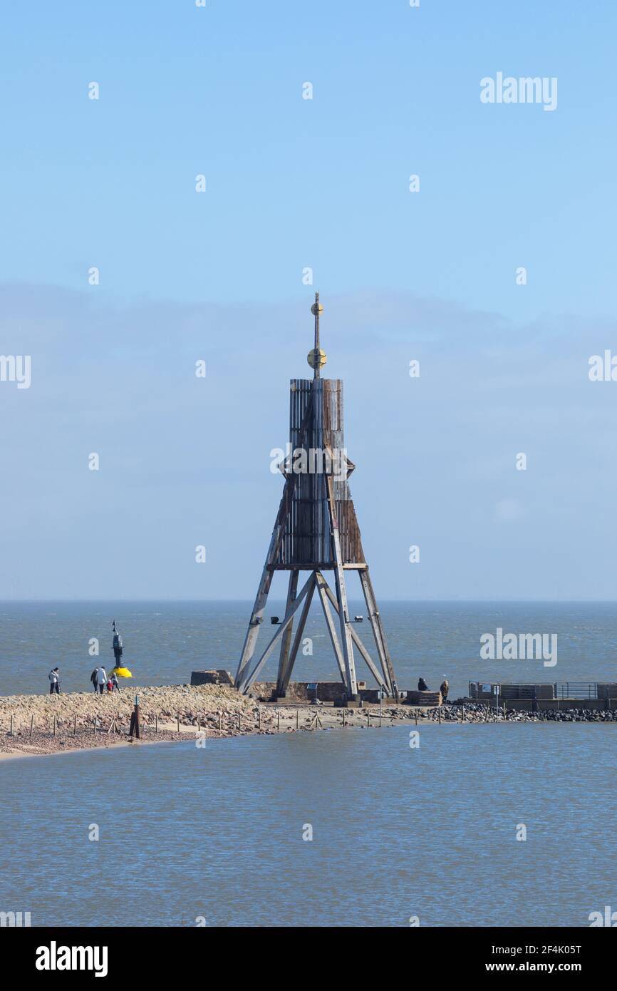 Cuxhaven, Germany - March 14, 2021: Day-trippers visiting Kugelbake beacon, landmark of the city on Elbe river estuary. Stock Photo