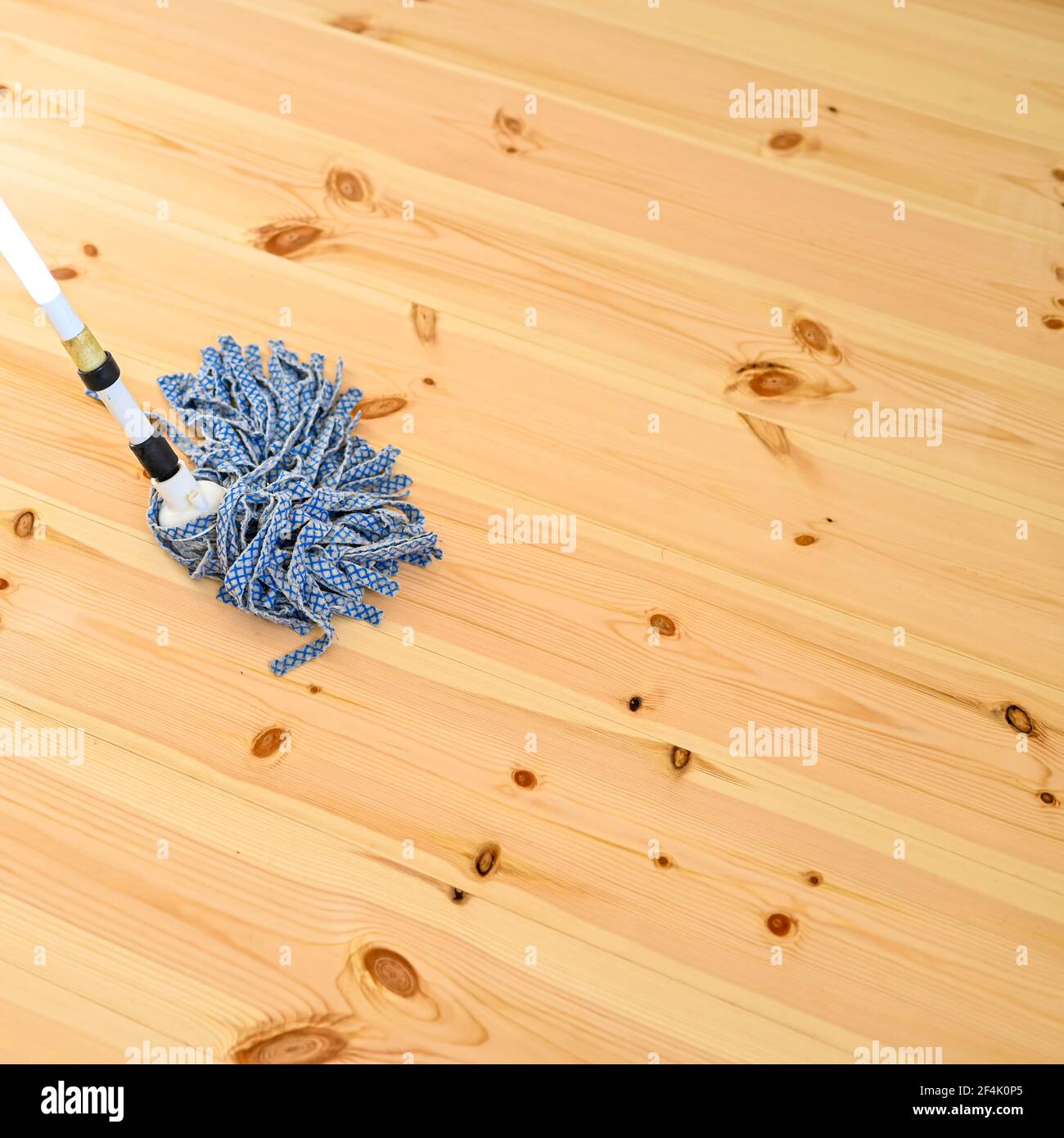 person mops new wooden floor with lots of twigs in Swedish home Stock Photo  - Alamy