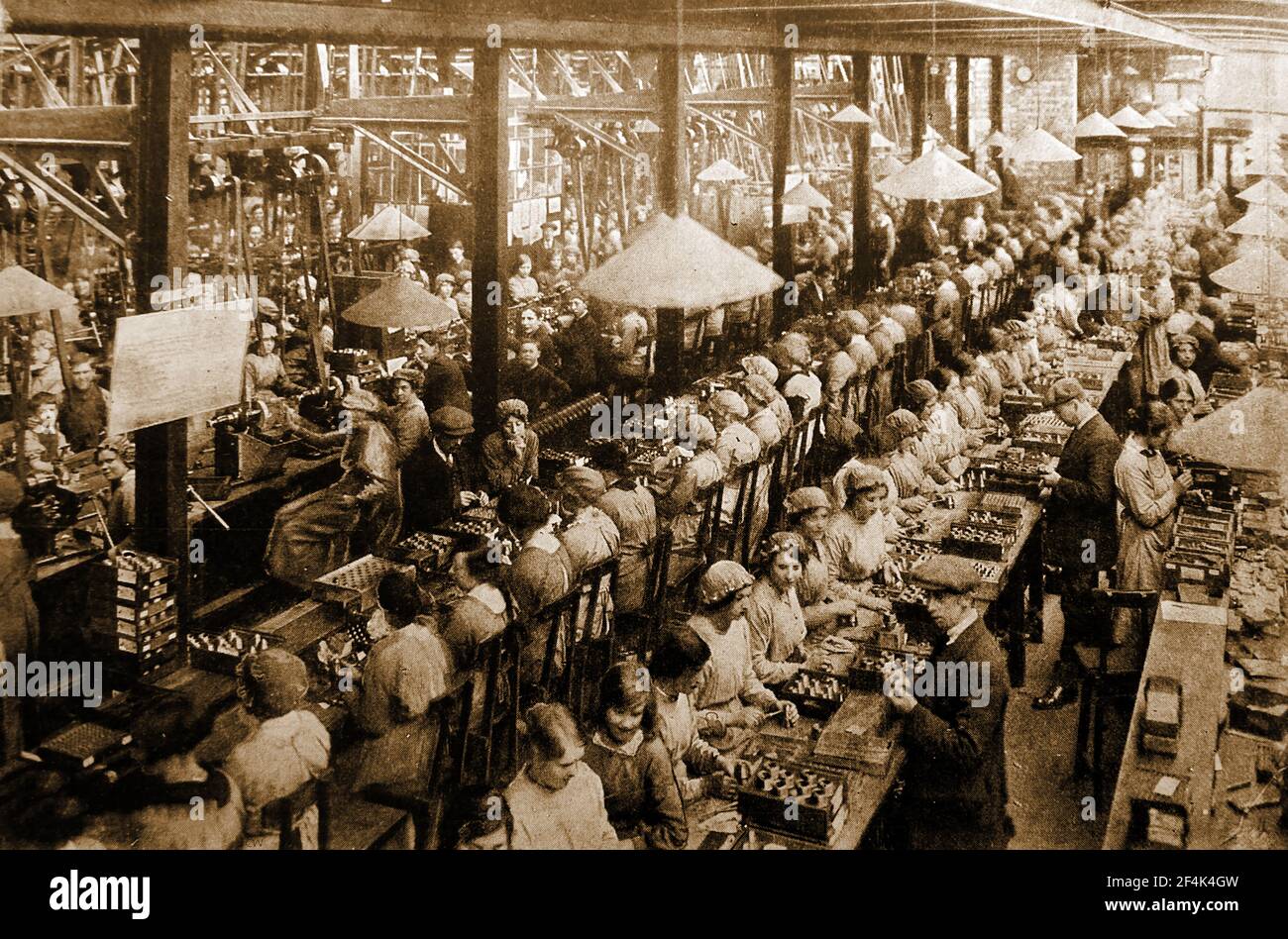 An old photograph taken during WWI showing predominately women & boy workers assembling shell fuses in a British munitions factory. Stock Photo