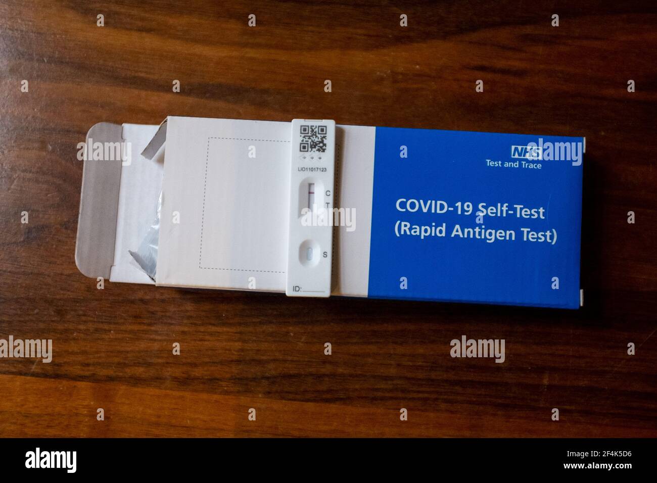 A covid-19 self test kit with a cartridge showing a negative test result. Stock Photo