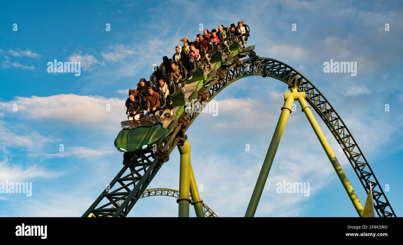 People screaming and holding up hands during roller coaster ride Helix ...