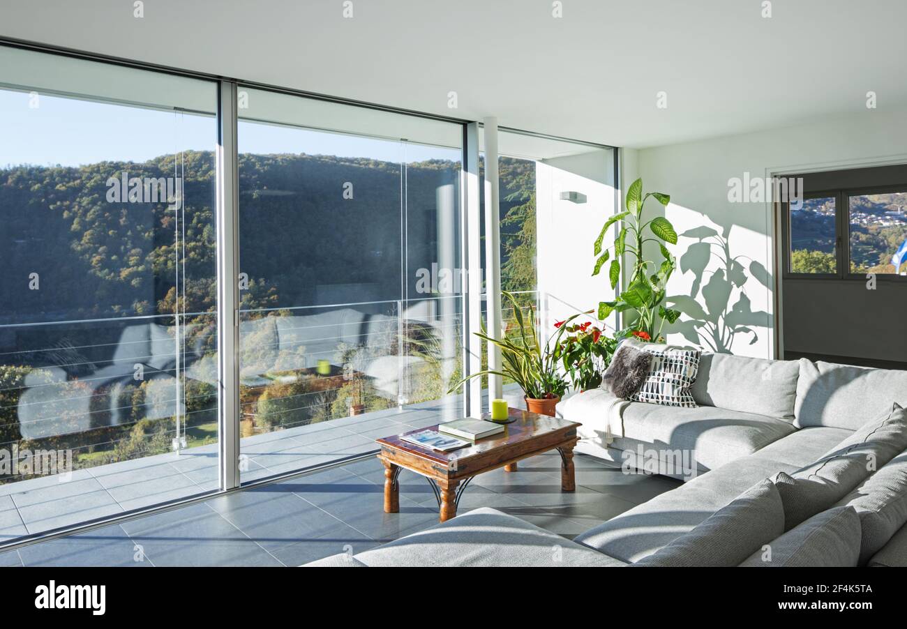 Living room with landscape view on the mountains and lake Stock Photo ...