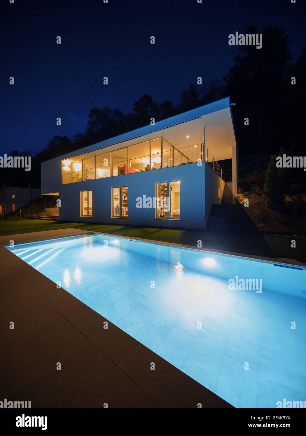 Modern house, exterior in the night, lights on Stock Photo