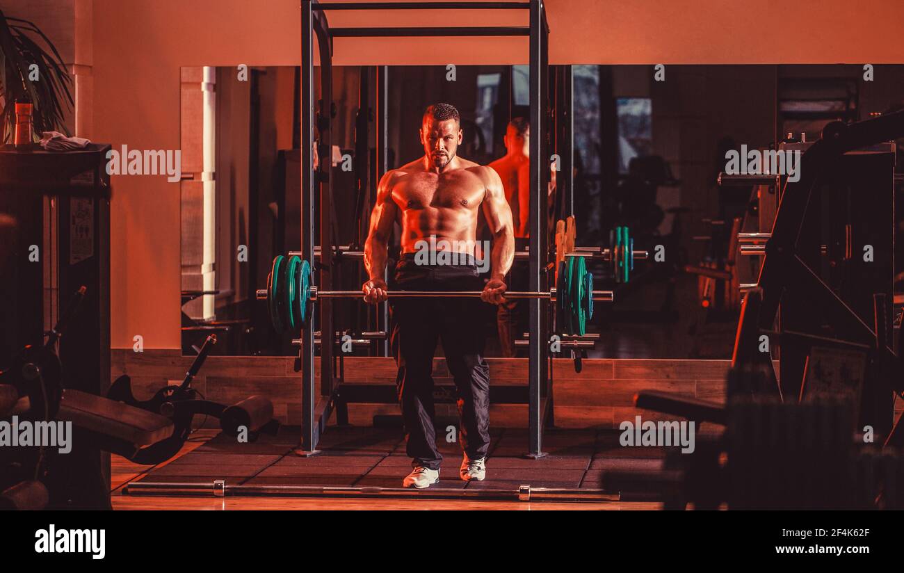 Bodybuilder athletic man with six pack, perfect abs, shoulders, biceps