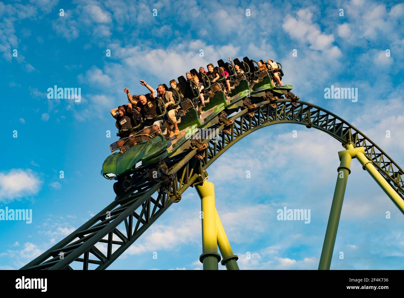People screaming and holding up hands during roller coaster ride Helix Stock Photo