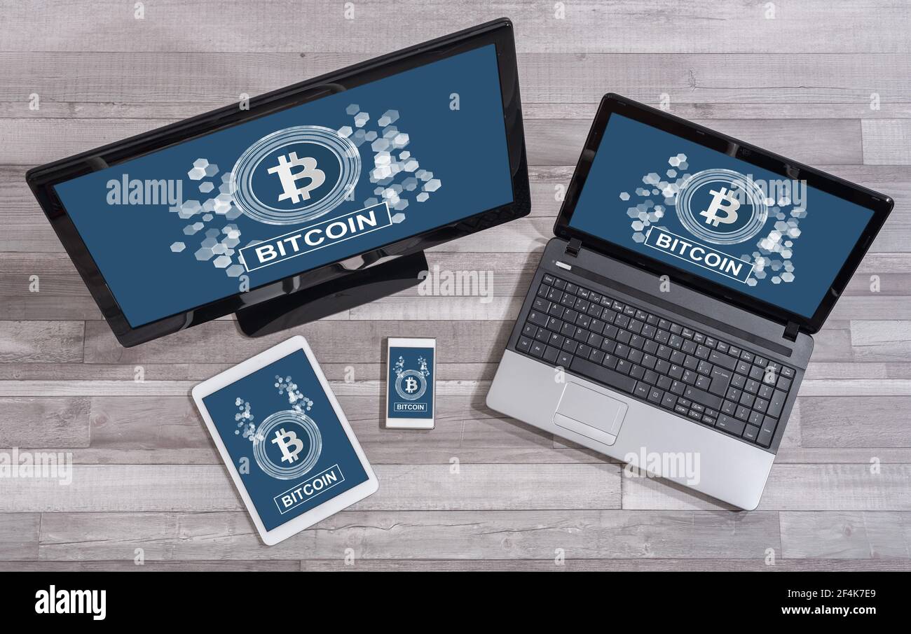 Bitcoin concept shown on different information technology devices Stock Photo