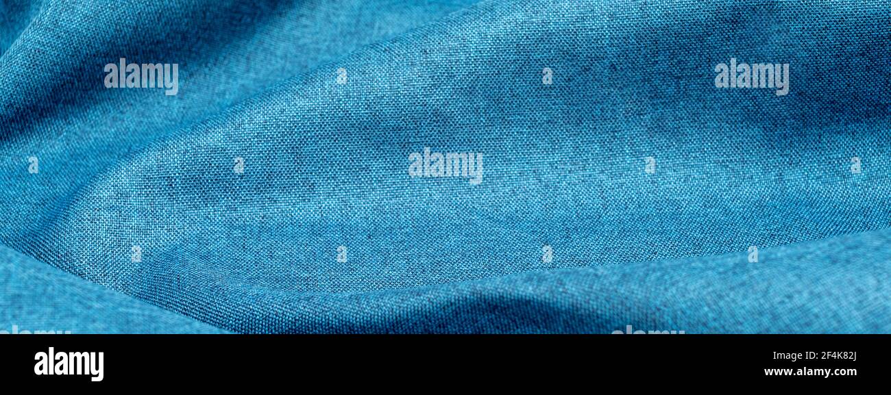 Banner background of blue cotton cloth with pleats. Crumpled azure ...