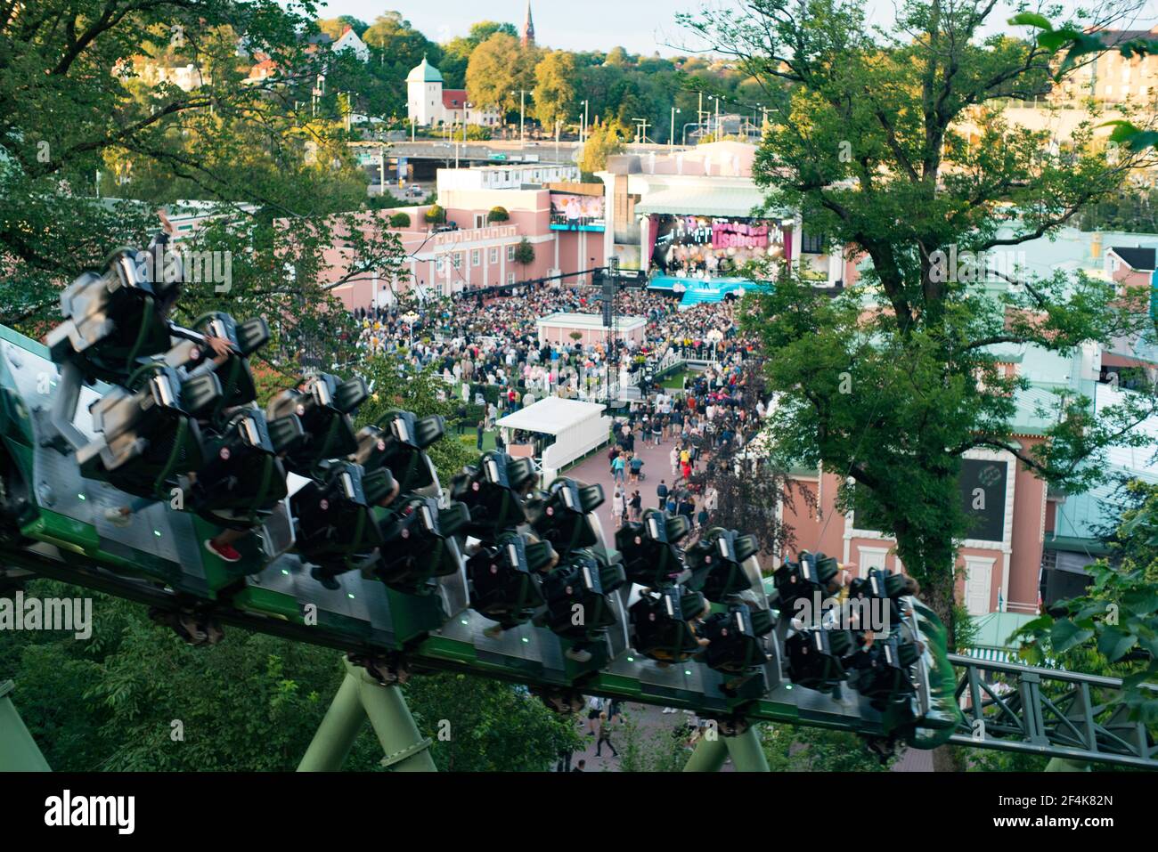 People screaming and holding up hands during Roller Coaster ride Helix Stock Photo