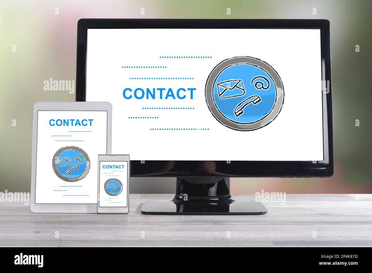 Contact concept shown on different information technology devices Stock Photo