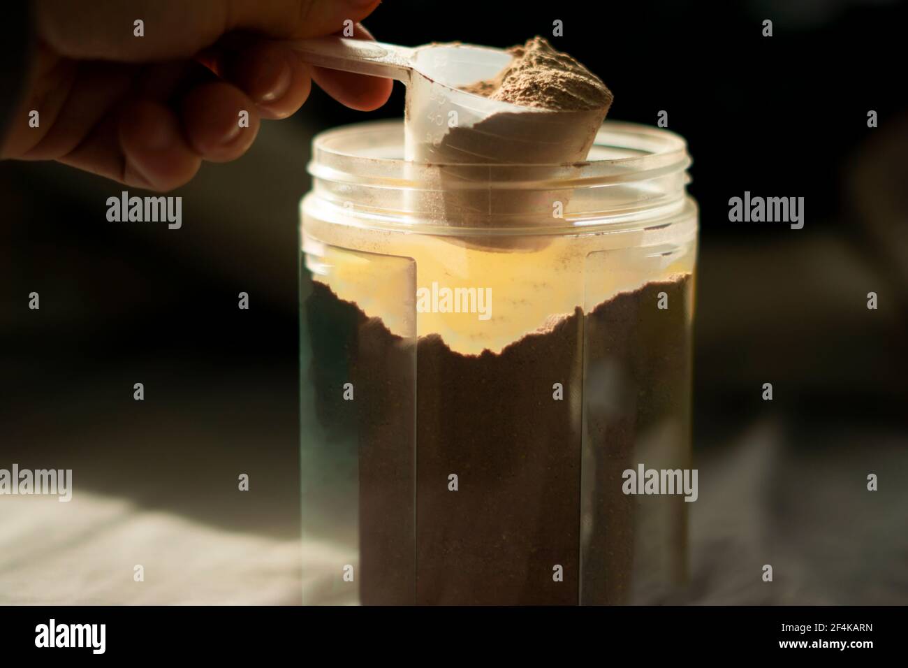 a scoop of chocolate whey protein Stock Photo