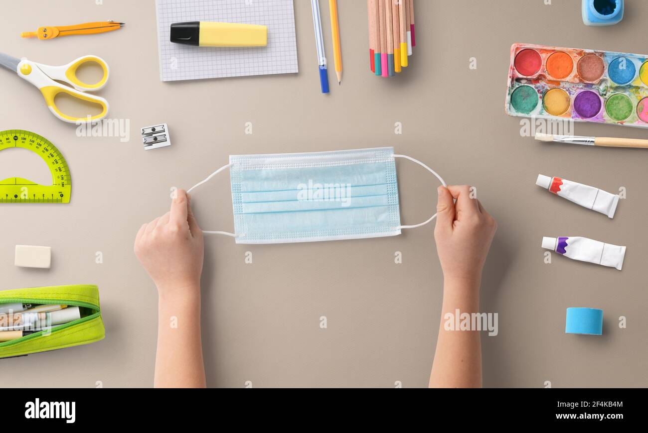 Flat lay top view of face mask and school supplies, back to school and ...