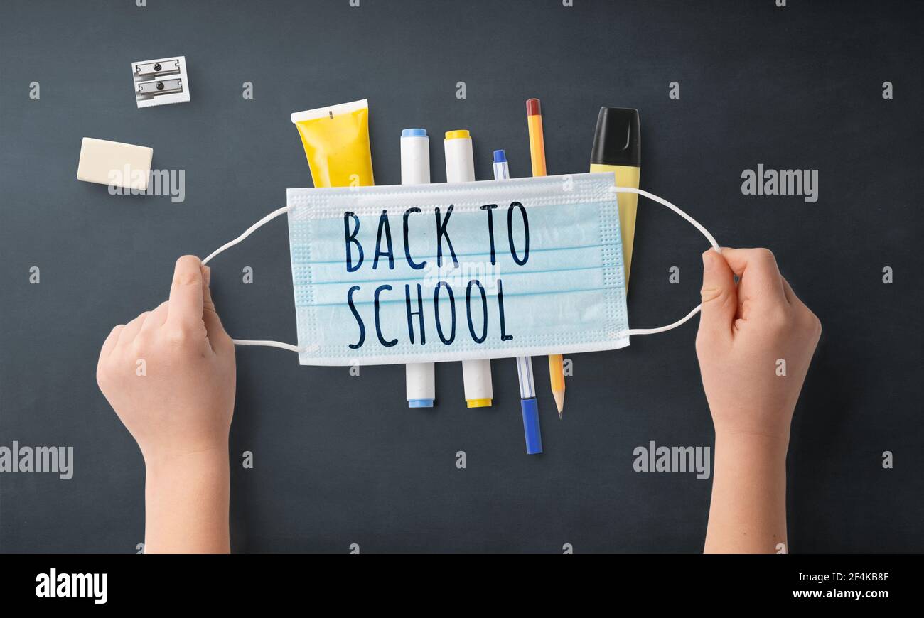 Flat lay top view of face mask and school supplies, back to school and ...