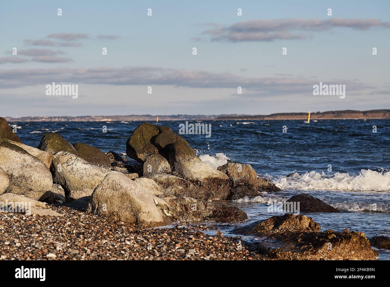 large rocks in the water on the beach Stock Photo - Alamy