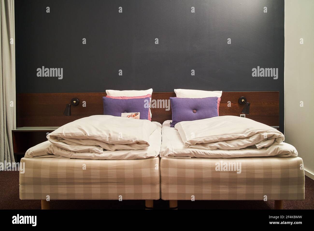 two small beds in a cozy hotel room Stock Photo