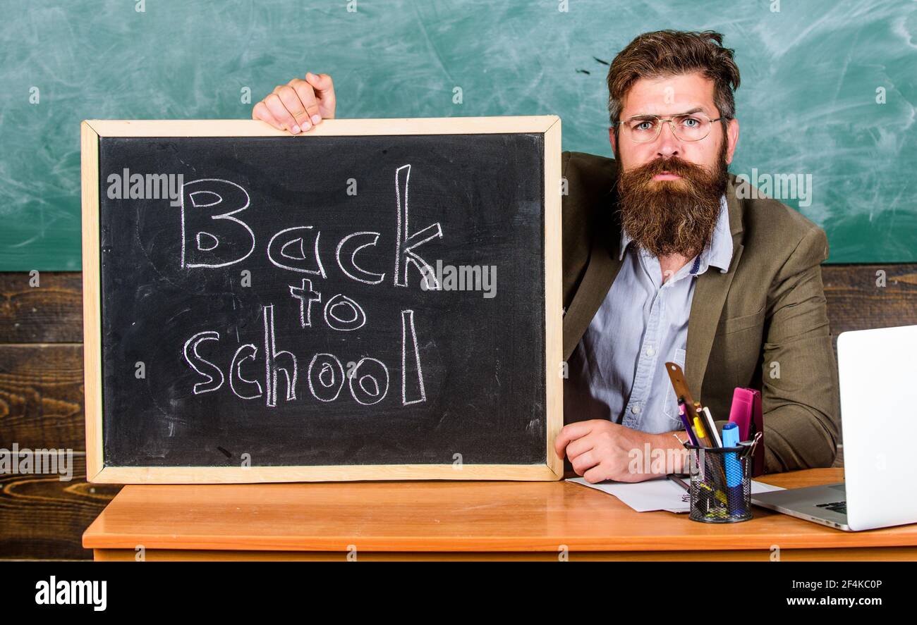 back. Teacher or school principal with blackboard