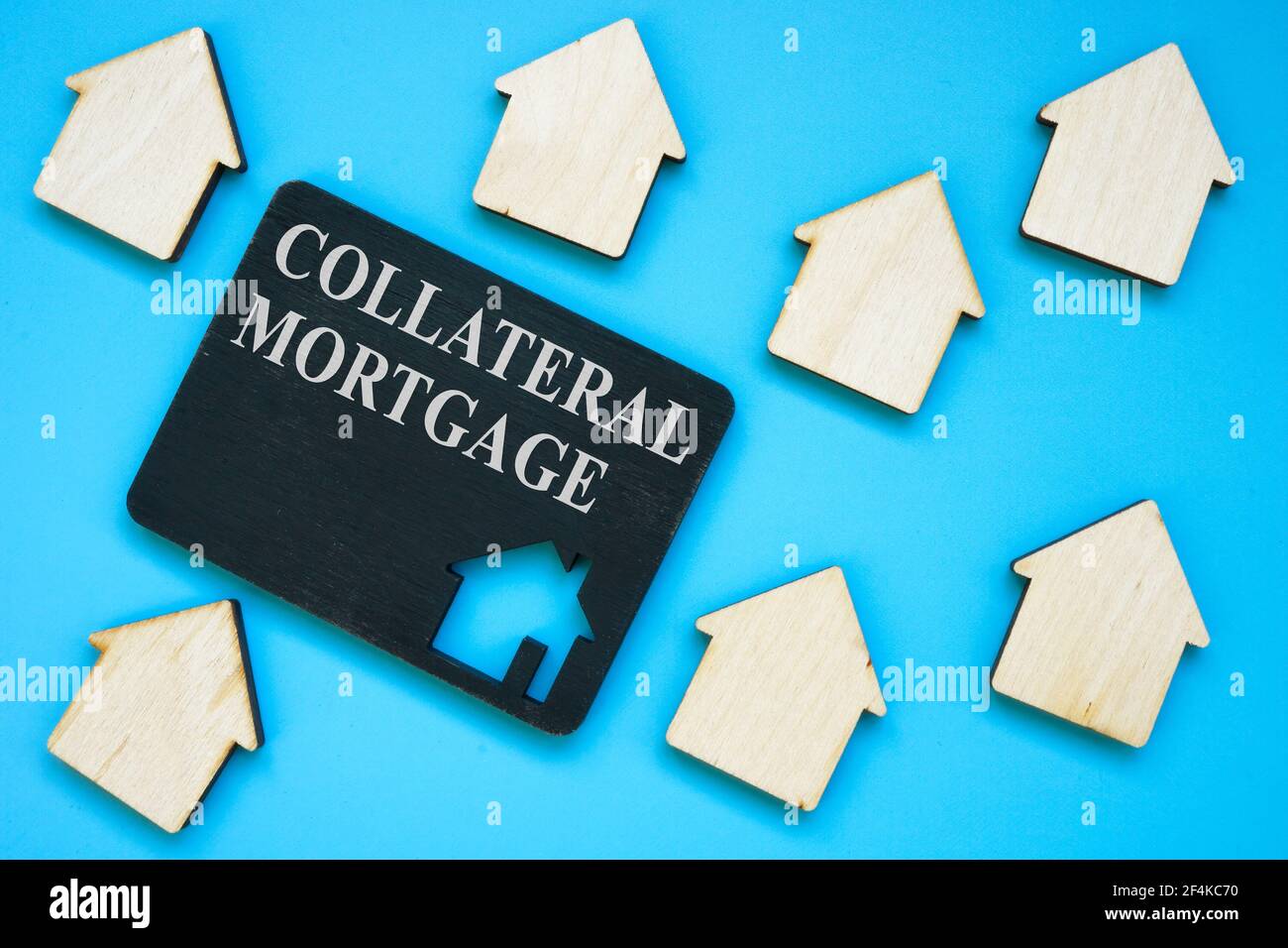 Collateral Mortgage sign on the plate and small houses. Stock Photo