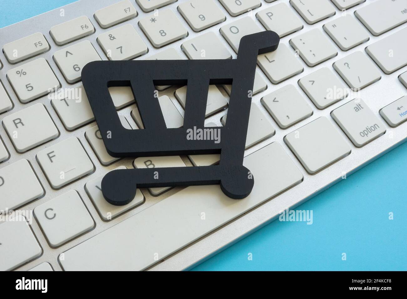 Shopping cart on the keyboard as symbol of online e-commerce. Stock Photo
