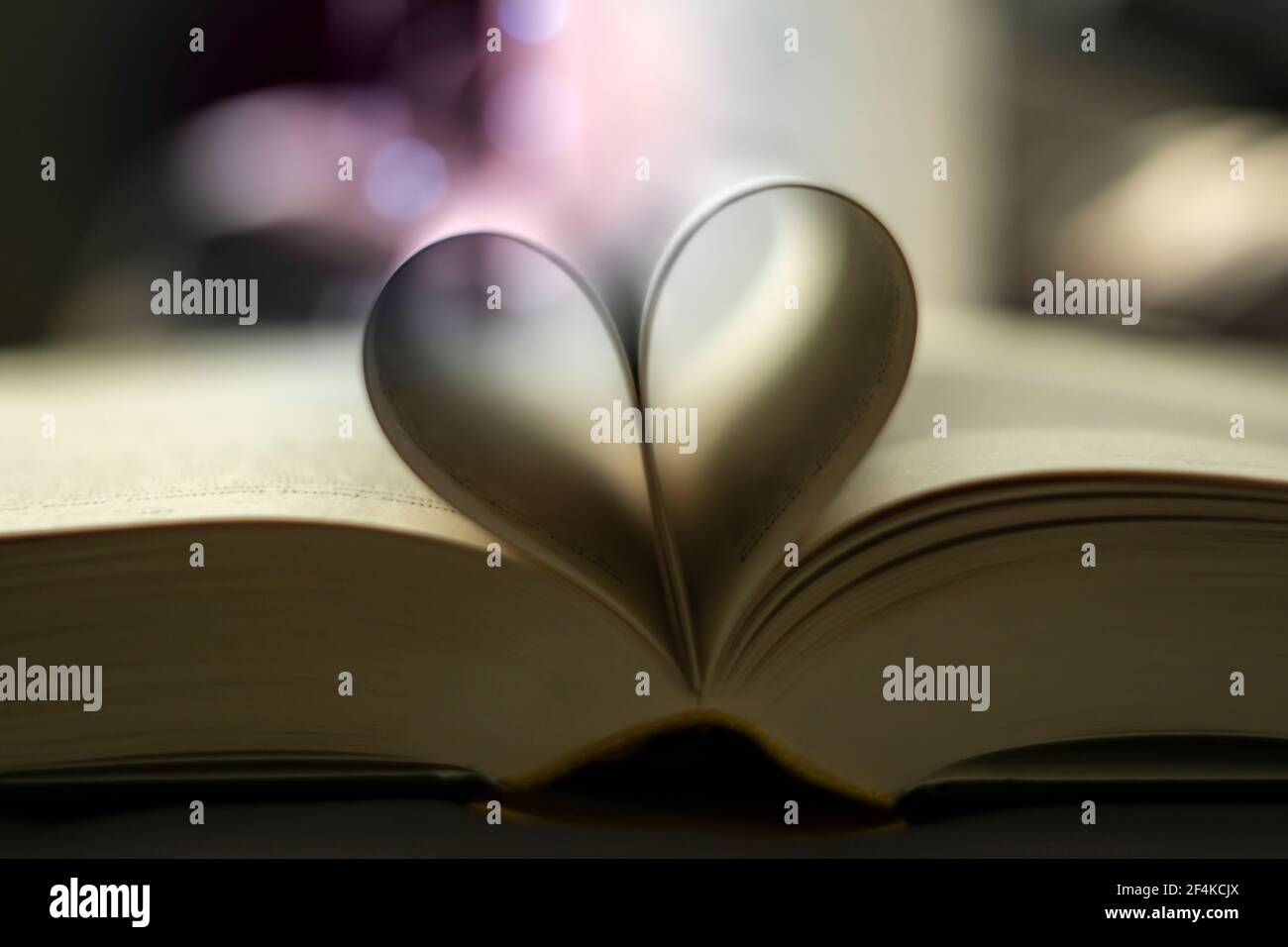 Heart-shaped Folded Book Art with light bubbles - valentine's day Stock Photo