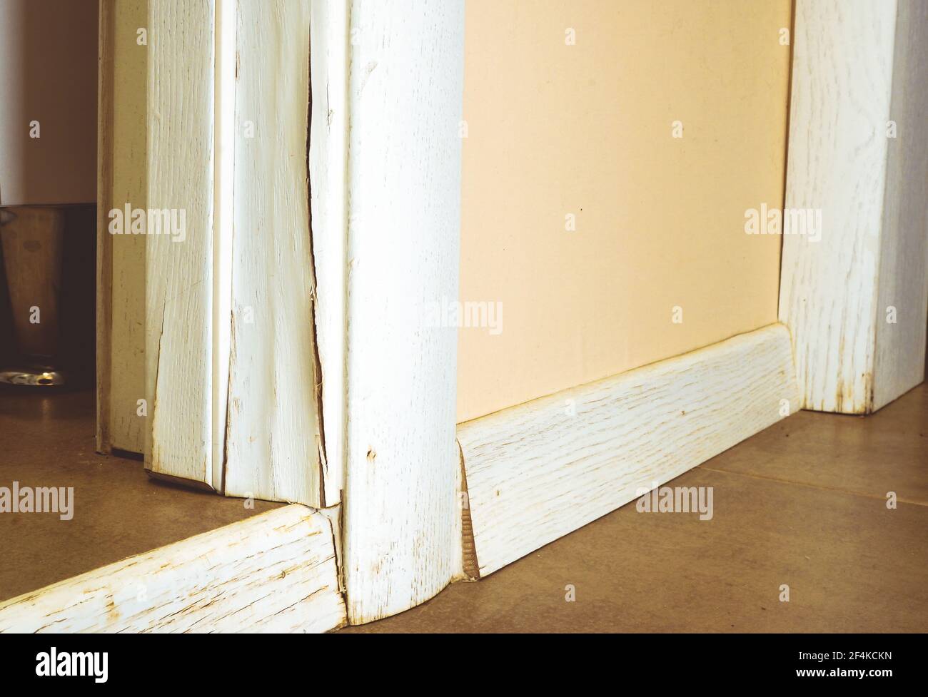 Crack in the wooden door casing after the apartment was flooded. Stock Photo